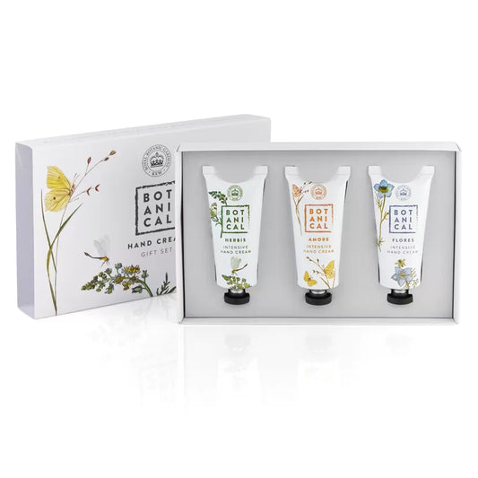 A gift set of three tubes of hand cream in a presentation box with botanical designs. three fragrances and all natural ingredients