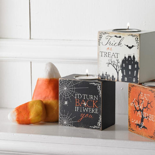 halloween candy corn decor in two different sizes sitting by 3 boxes