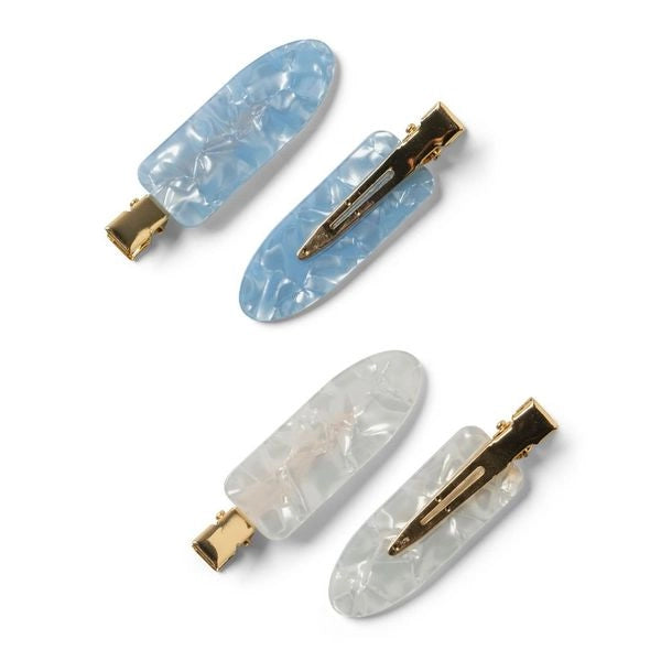 A set of four hair clips in two colors, blue and white, with a marbled design and metallic gold clasps. showing front and back of clips