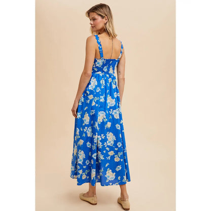back view of floral blue maxi dress with scalloped strap detailing and pockets 