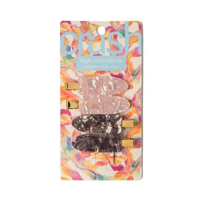 A set of four hair clips in two colors, gray and pink, with a marbled design and metallic gold clasps with packaging 