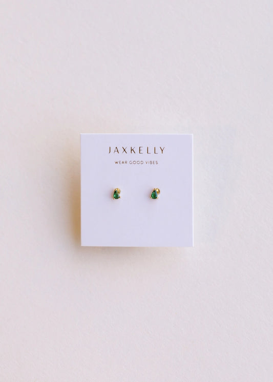 image of a pair of emerald teardrop stud earrings on plain background