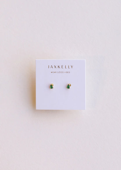 image of a pair of emerald teardrop stud earrings on plain background