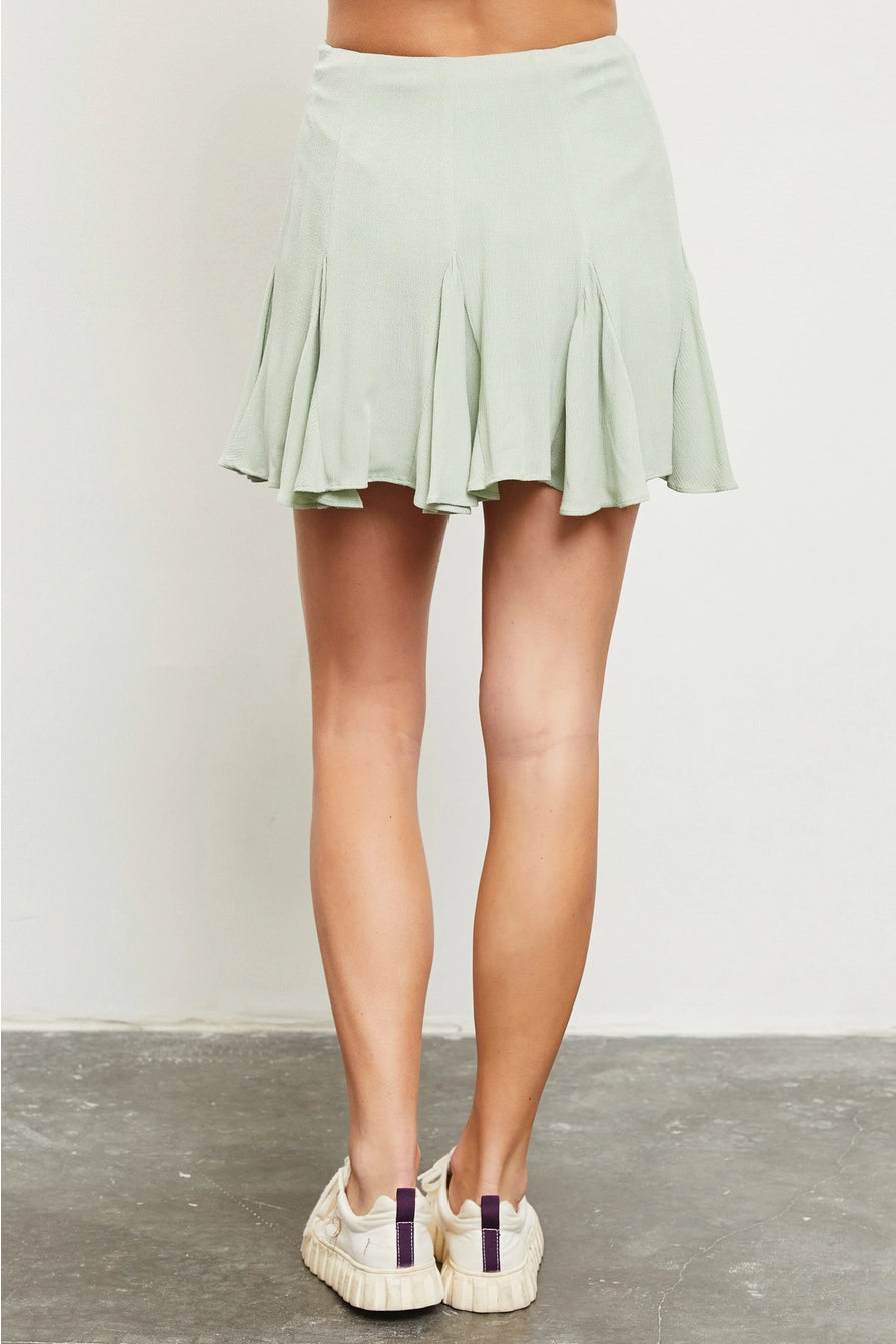 light green flared skort back view, shown with sneakers