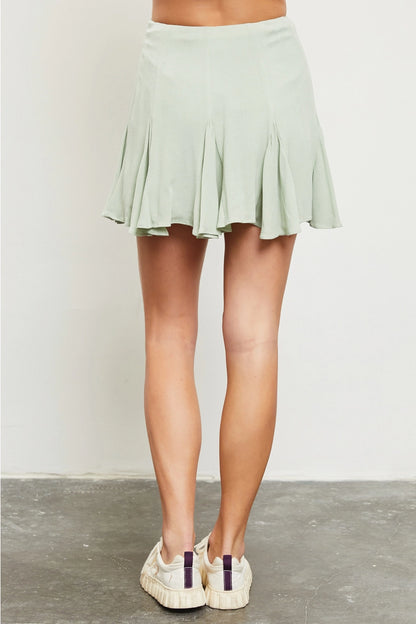 light green flared skort back view, shown with sneakers