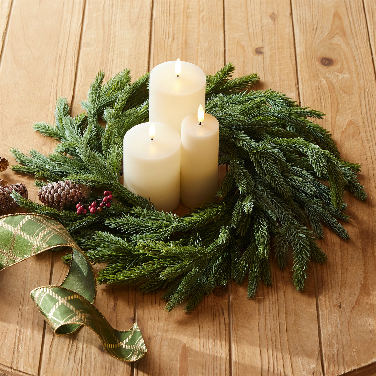 Spruce candle ring wreath with three white pillar candles and pine greenery