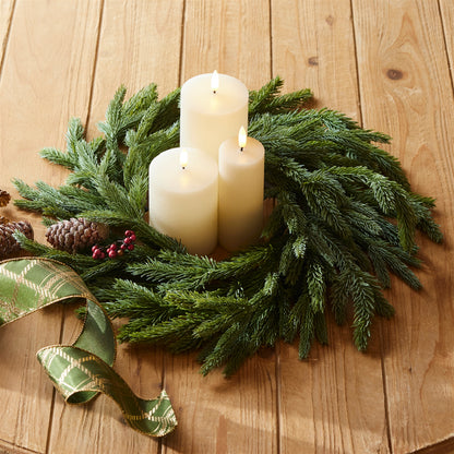 Spruce candle ring wreath with three white pillar candles and pine greenery