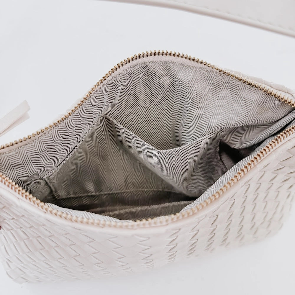 Woven shoulder bag with chevron interior lining and zippered top opening