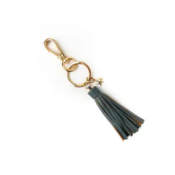 Keychain with tassel and gold accents on a white background