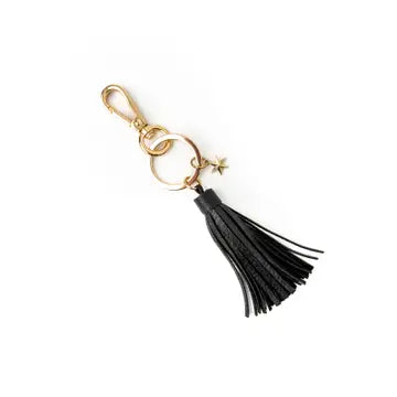 Black tassel keychain with gold accents on a white background