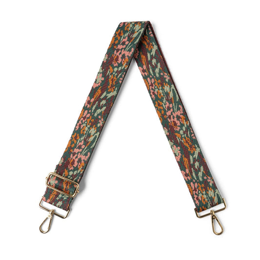 A multicolored floral patterned interchangeable strap for bags with metal hardware.