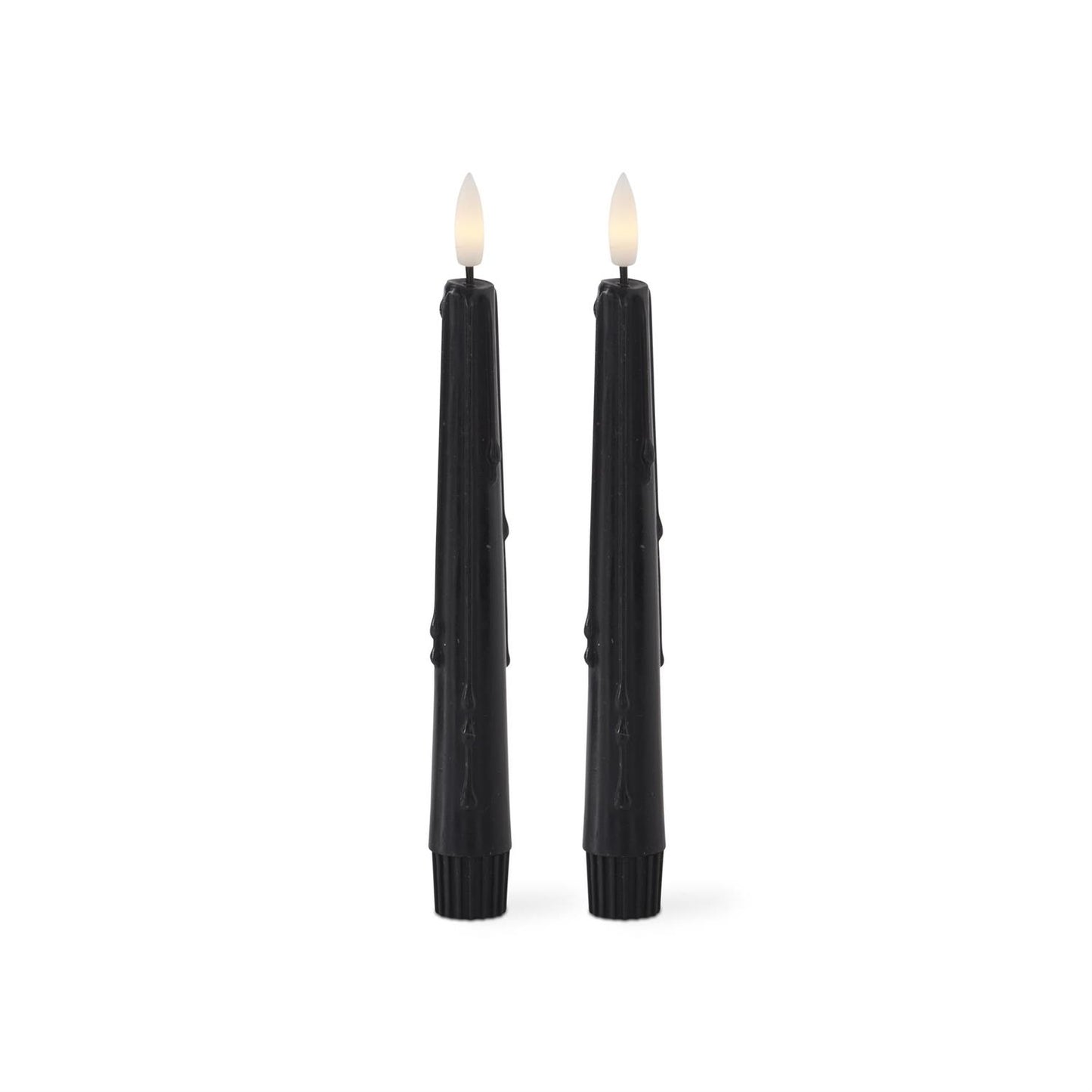 Two black candles with wicks on a white background