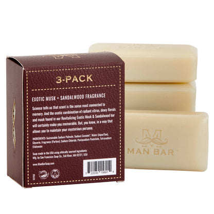 Three bars of soap with a packaging box displaying text and barcodes.