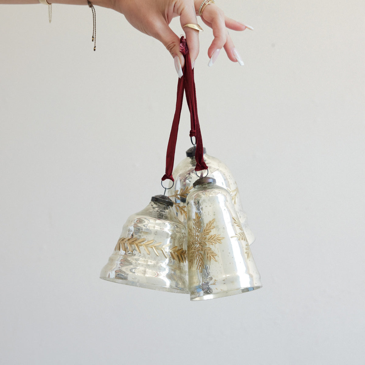 Mercury glass bell ornaments with burgundy velvet ribbon, gold etched snowflake accents