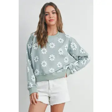 mint colored daisy sweatshirt for cool weather shown on model with shorts