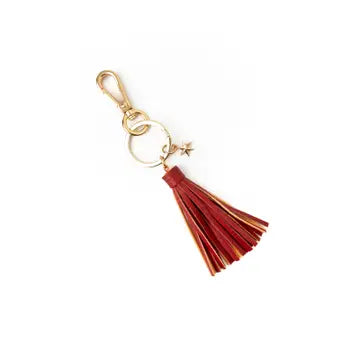 Red tassel keychain with gold accents on a white background