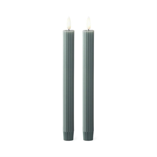 Two gray green candles on a white background